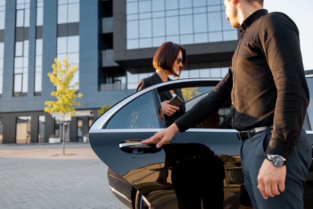 Chauffeur opening the door for a passenger